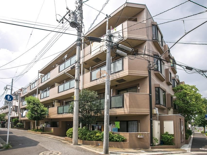 4階建ての低層構成で、角地に沿って建物が伸びる外観は、周囲の住宅街に自然に溶け込んでいます。道路幅は広すぎず、車の音も控えめで、歩いていると街の生活音が穏やかに伝わる距離感です。「中板橋駅」徒歩15分と聞くと少し歩きますが、その分「板橋区立大谷口小学校」徒歩2分、「オーケー 大谷口店」徒歩3分という足元重視の暮らしが成立する立地といえます。