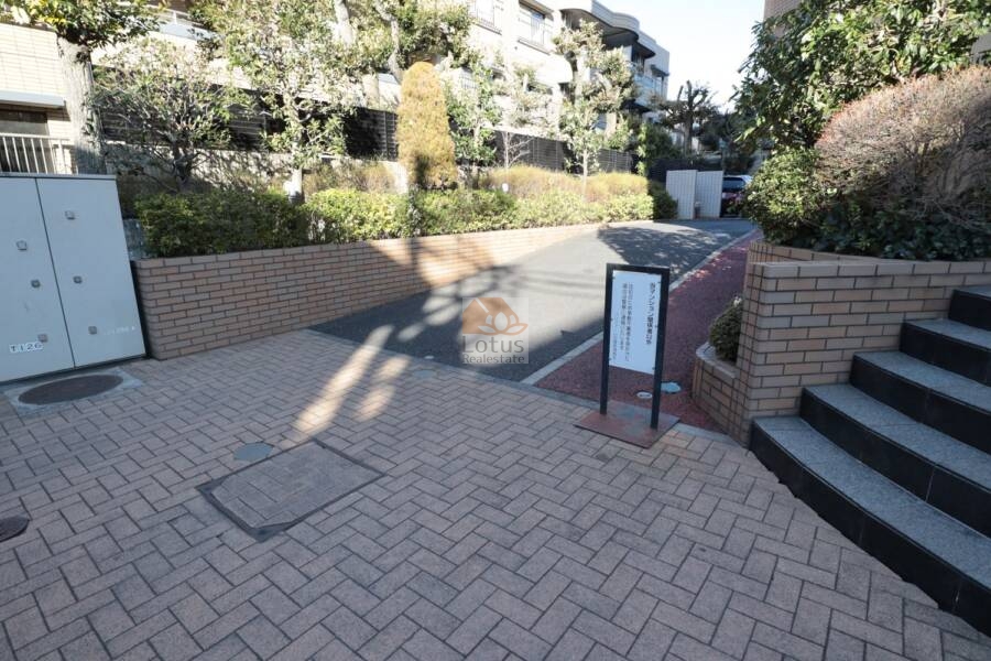 コンファーレ白鷺共用部5｜車両進入路と住戸側の動線が分離された設計になっていて、プライバシーへの配慮が見て取れます。マンションの佇まいに、落ち着きと清潔感が息づいています。