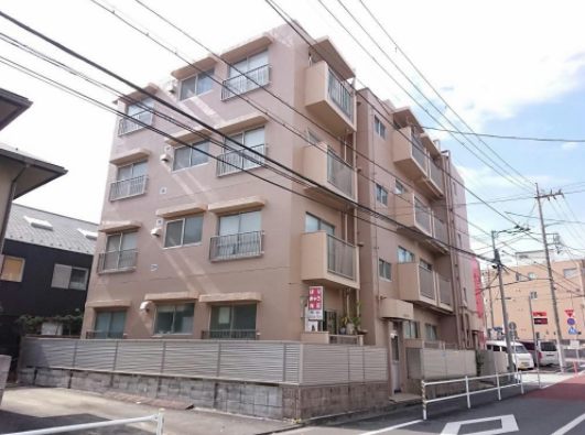 大洋江古田マンション外観１｜大洋江古田マンションは昭和46年築、大通りから奥まった場所に建つ4階建ての低層マンションで、シンプルなタイル貼り外観が特徴です。昭和築ながら落ち着きのある佇まいで、静かな住環境に調和しています。